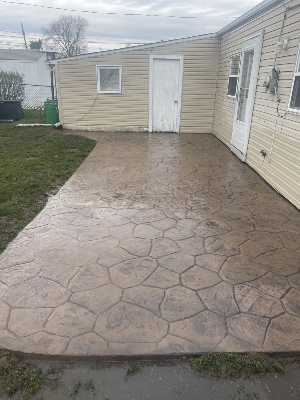 Tan flagstone-pattern stamped concrete patio